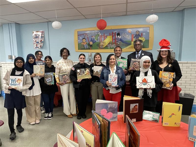 Texas Avenue School volunteers show favorite books for Read Across America.